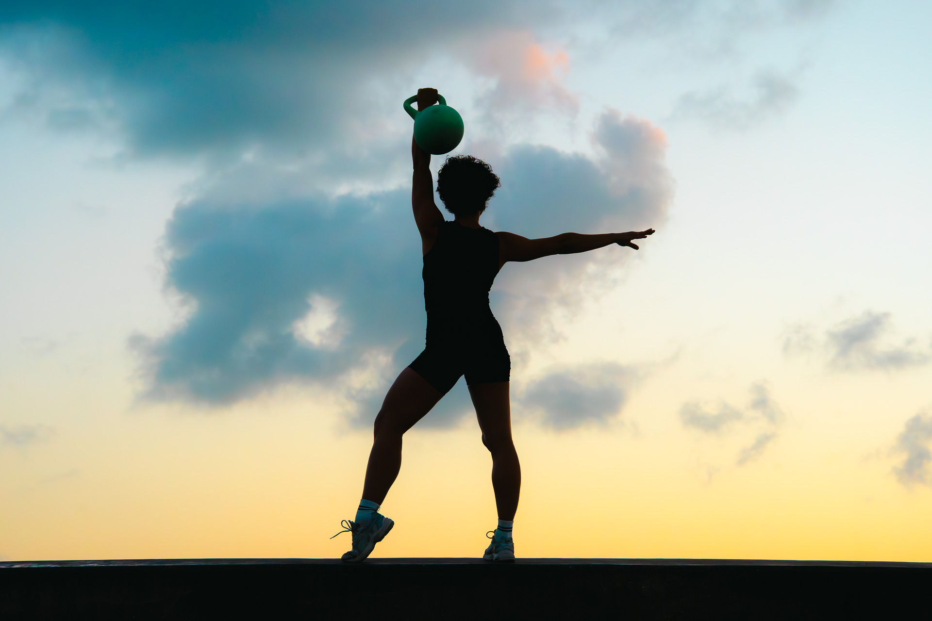 Laura Treto, sunset overhead kettlebell