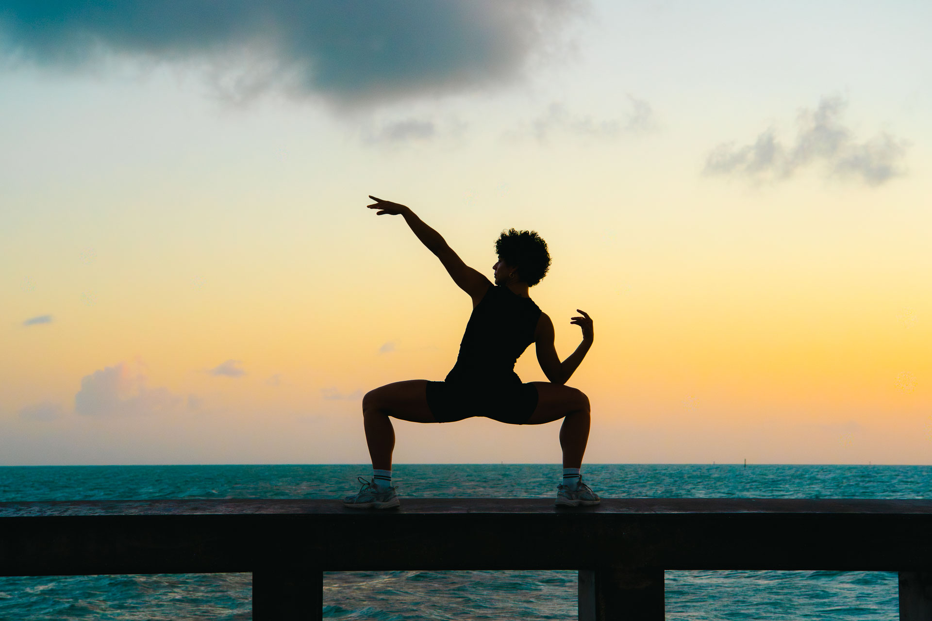 Laura Treto, sunset squat on the pier