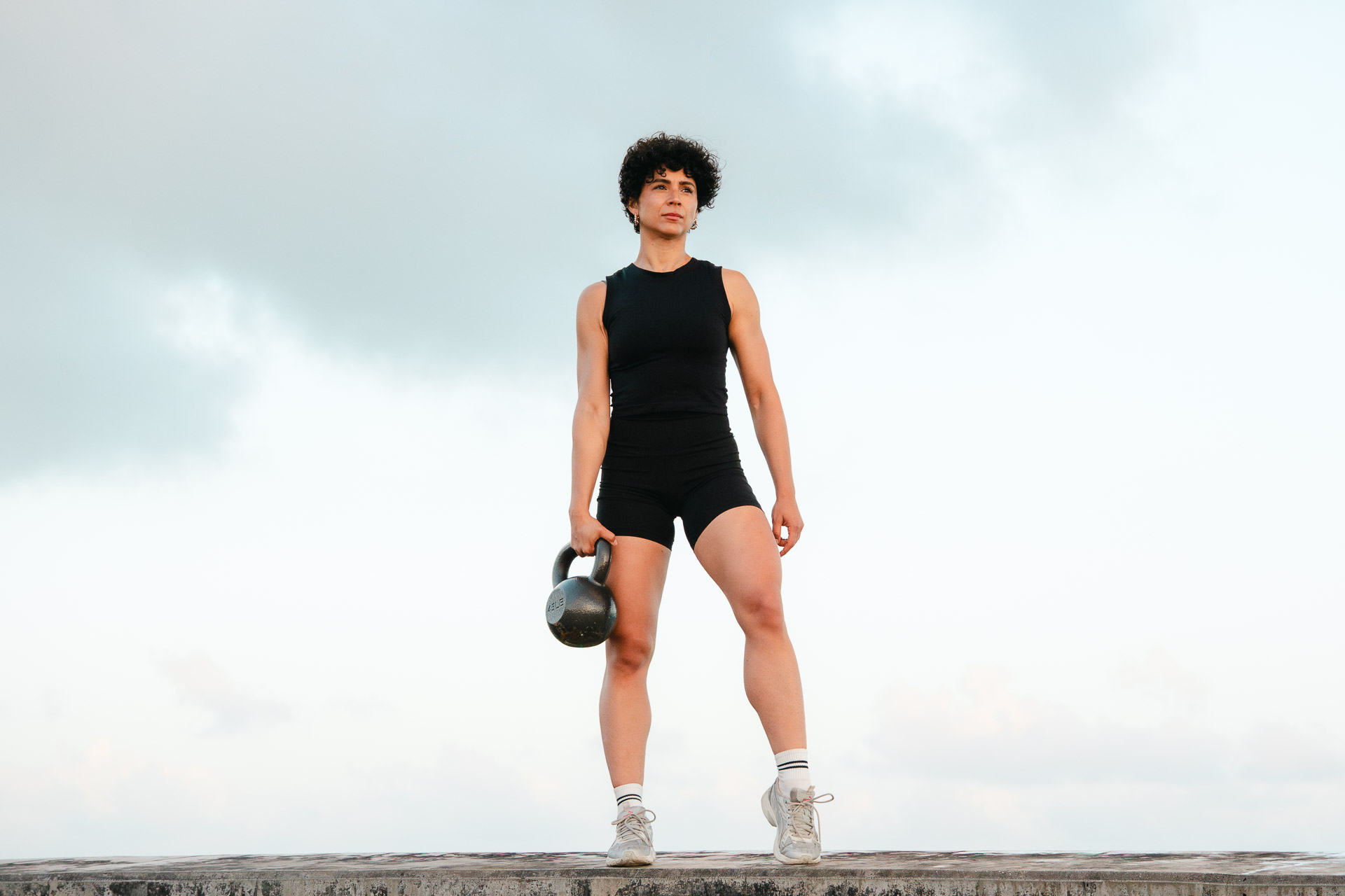 Laura Treto standing with a kettlebell for Strength Snacks