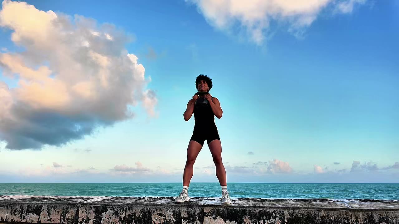 Laura Treto kettlebell exercise by the ocean